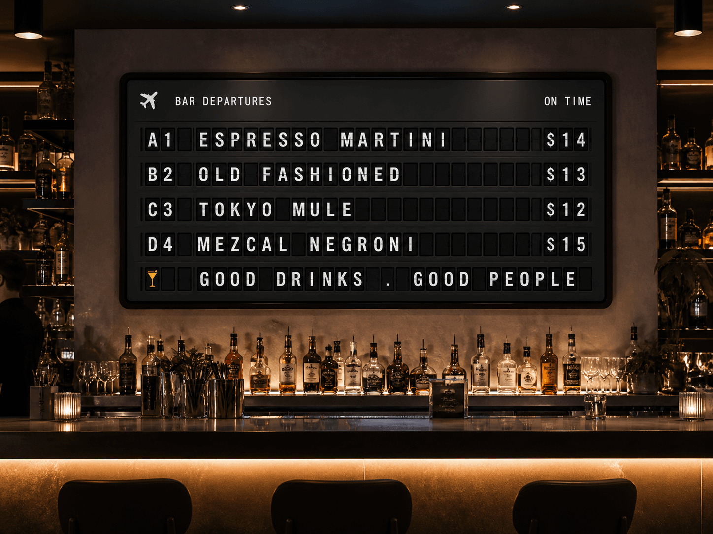 A dark bar interior with a large split-flap departures board listing cocktails and prices.